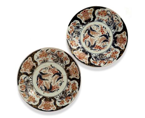 A PAIR OF 19TH CENTURY JAPANESE IMARI CHARGERS with old repairs and rivets, each 36.5cm diameter (2)