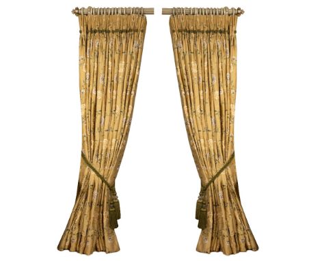 A PAIR OF GOLD GROUND INTERLINED CURTAINS decorated with green branches and yellow and gold flowers, each curtain approximate