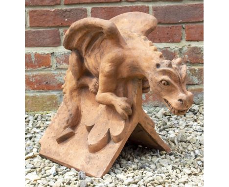 A TERRACOTTA RIDGE TILE with perch dragon finial 51cm long x 31cm wide x 45cm high