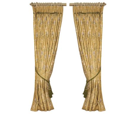 A PAIR OF GOLD GROUND INTERLINED CURTAINS decorated with green branches and yellow and gold flowers, each curtain approximate