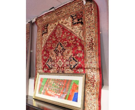 A Heriz style rug having a medallion on a red field with ivory spandrels surrounded by one frieze and two running borders  19