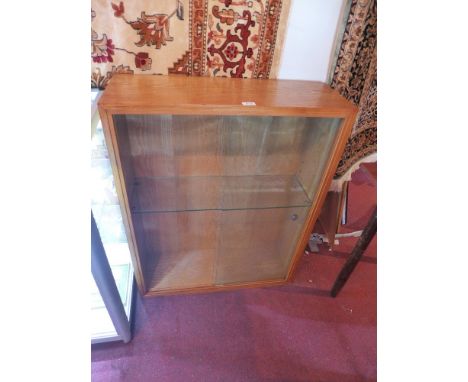 A honey oak display cabinet having two sliding glass doors and a glass shelf H:97cm W:77cm D:27cm