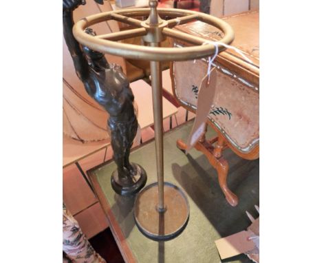 A brass stick stand on a cast iron base, H:66cm