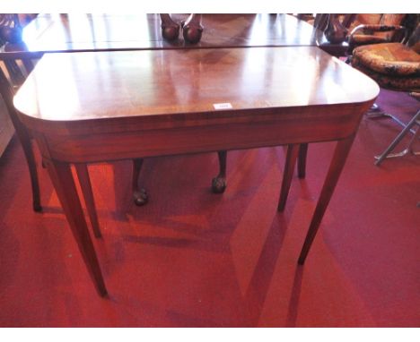 A 19th century mahogany card table with box wood inlay and raised on tapered legs