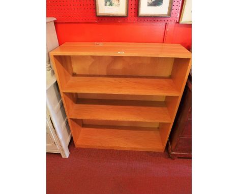 A mid 20th century light oak three tier bookcase. H-106cm W-98cm D-30cm