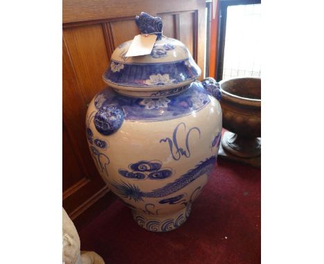 A large Chinese blue and white temple jar and cover, decorated with a dragon chasing a flaming pearl. H-80cm