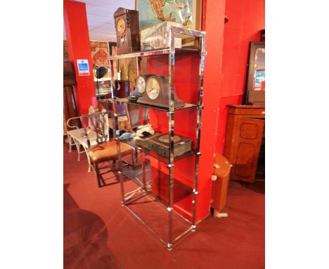 A vintage chrome shelving unit, having four smoked glass shelves H:181cm W:86cm D:37cm