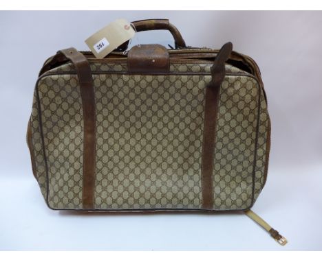 A vintage Gucci suitcase with brown leather straps H:55cm W:62cm D:14cm