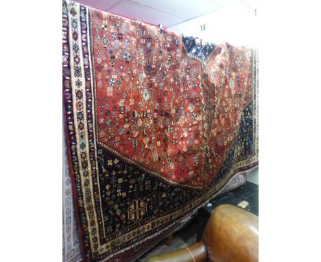 A South West Persian carpet , 295cm x 210cm, the central double pendent medallion with repeating animal motifs on a terracott