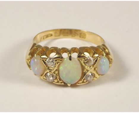 OPAL RING. An Edwardian 18ct. gold opal & diamond ring, the stones of good colour. Chester 1909. Size I.