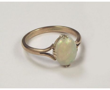 OPAL RING. A yellow metal ring set an opal.