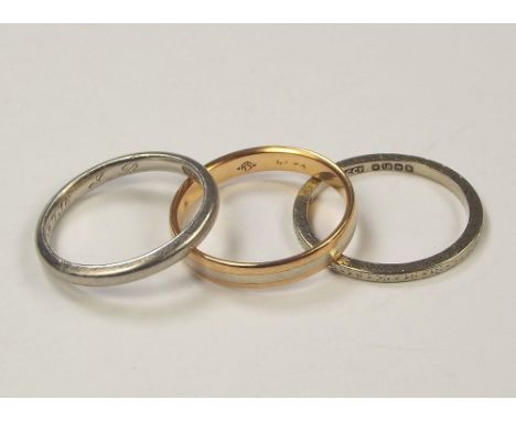 GOLD RINGS. A platinum band, size K/L (approx. 3.5g), an 18ct. white gold band, size L/M (approx 1.8g), & one other band, siz