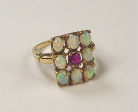 OPAL RING. A 9ct. gold opal & ruby ring. Face 1.5 x 1cm. Size M/N.