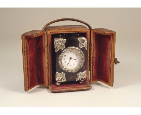 MINIATURE CLOCK.An Edwardian miniature tortoiseshell carriage clock, with applied silver coloured metal mounts. Back plate un