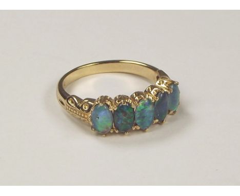 OPAL RING. A 9ct. gold five stone opal doublet ring.