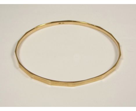GOLD BANGLE. A 9ct. gold slave bangle with original presentation wallet. Approx.19.4g.