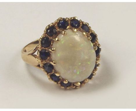 OPAL RING. A 9ct. gold opal & sapphire dress ring. Size I.