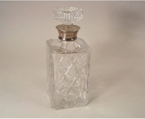 DECANTER. A 1970's silver mounted, cut glass decanter. Height 24cm.