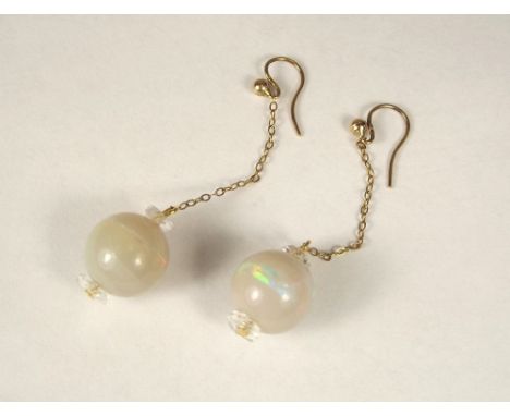 OPAL EARRINGS. A pair of 9ct. gold mounted opal earrings. Each opal approx. 10ct. Length 6mm.