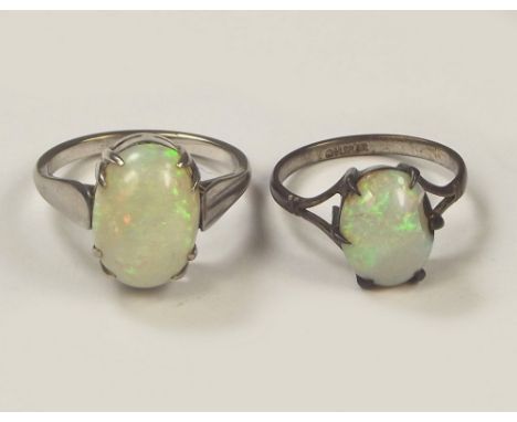 OPAL RINGS. A small silver mounted opal dress ring & one other opal ring set in white metal.