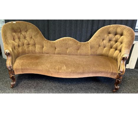 A Victorian walnut double spoon back sofa, with a button back &amp; seat with scroll arms, standing on shaped front supports 