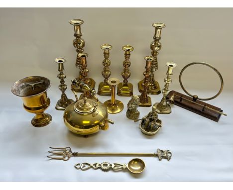 A mixed lot of brass ware, to include candlestick holders, teapot, toasting fork, Welsh love spoon.