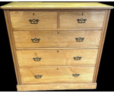 An light oak chest of drawers, the shaped surface above two short drawers, three long drawers, raised on a plinth base. [ 102