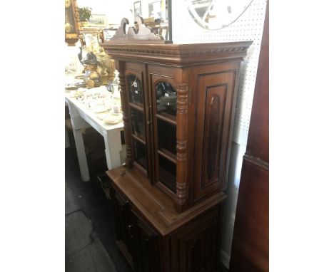 A mahogany two door cabinet on cupboard base