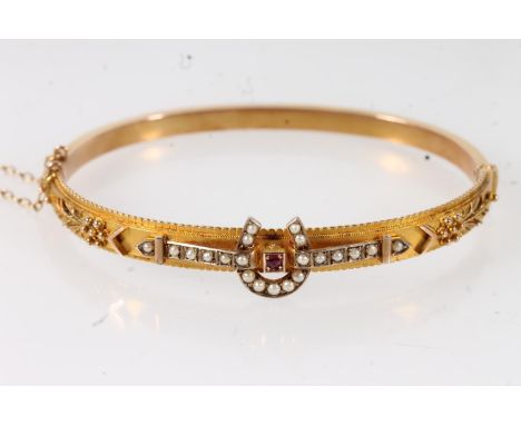 Victorian 9ct yellow gold snap shut bangle set with horseshoe shaped pearl front and central ruby, the bangle with Etruscan R
