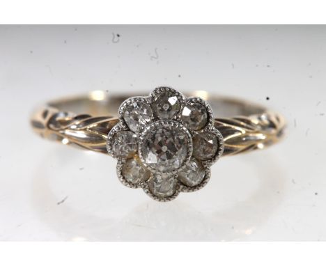 18ct yellow gold ladies diamond flowerhead ring, the central stone surrounded by eight smaller diamonds, size K, 2.6g.