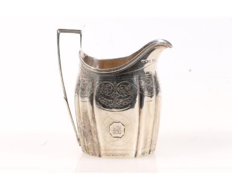 Geo. III silver cream jug, of helmet form with angular handle, the body bright cut engraved with floral swags and a heraldic 