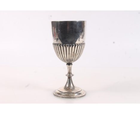 Edwardian silver trophy, of chalice form, the half lobed body over a knopped stem raised on a round foot with beaded rim, the
