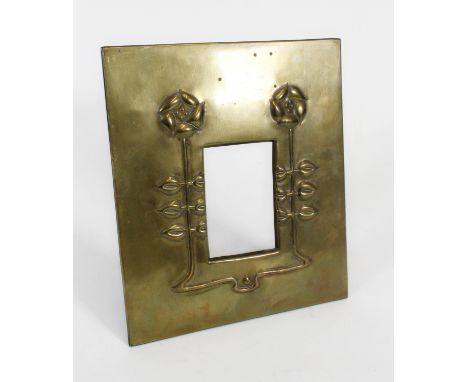 Art Nouveau Glasgow School style brass photo frame, c1910, embossed with a a pair of roses on straight leafed stems, on easel