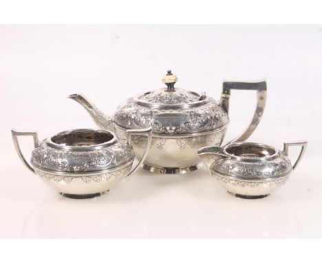Victorian silver three piece teaset, the teapot of squat ovoid form with angular handle, the body embossed and engraved with 