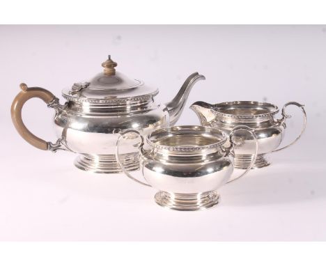 Geo. V three piece silver tea service, the teapot with bakelite finial and loop handle, Blackmore and Fletcher, London 1930, 