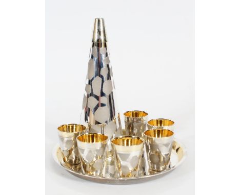 Russian white metal and gilt liquor set, 1970s USSR period, the bottle of tapering form with textured patch work design, with