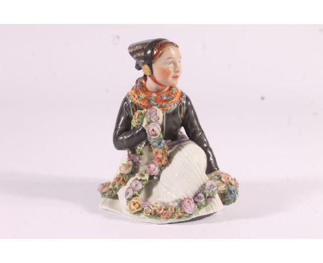 Royal Copenhagen figure of an Amager girl, in traditional dress holding floral swag, H13cm.