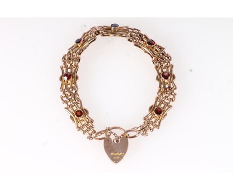 9ct gold gate bracelet set with faceted garnets and heart shaped padlock closure, 19.5g gross.