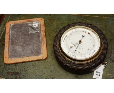 A vintage aneroid circular barometer, by R&T McInnes of Glasgow, with fahrenheit and centigrade thermometers, in carved frame