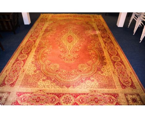 A Kashan style carpet, with central medallion over pink ground, floral spandrels and borders, 485 x 300cm