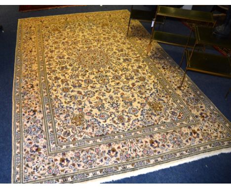 A Kashan carpet, the central medallion over floral design on cream ground with triple borders, 300 x 193cm CONDITION REPORT: 