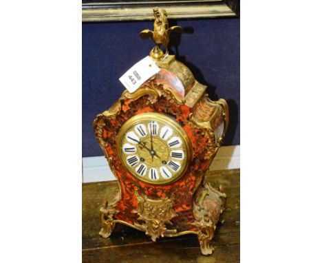 A 19th century French boule mantle clock, with gilt metal cockerel surmount above white enamel and gilded dial, decorated wit