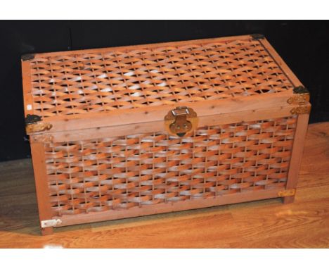A Chinese wicker trunk, decorated with brass strap hinges and mounts, with hinged lid, 41cm high x 80cm wide