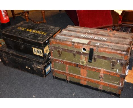 A vintage wood bound and canvas travel trunk, with hinged lid enclosing fitted rack, together with two vintage tin travel tru