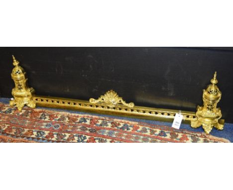 A gilded metal fire fender, in the new classical style, with pierced decoration