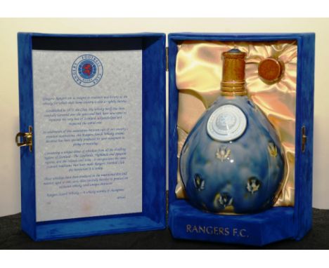 A Rangers Football Club wade ceramic whisky flagon, with contents and blue velvet outer box and stopper, 20cm high