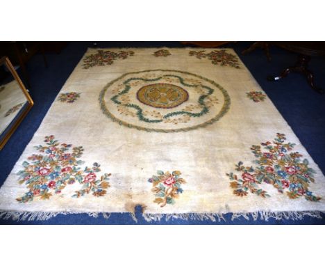 A large Indian carpet, the central medallion over cream ground and floral spandrels, 410 x 318cm