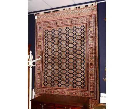 A Bokhara motif carpet/wall hanging, with five rows of 17 guls, over block ground and border, 300 x 160cm