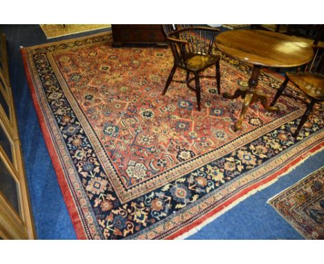 A Mahal carpet, with allover geometric floral design, over red ground with floral border, 394 x 295cm
