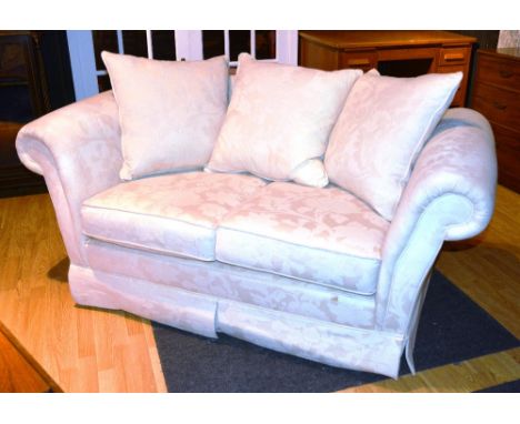 A two seater sofa, with loose cushion back and seat, scroll arms, upholstered in cream floral fabric, 175cm wide x 80cm high 